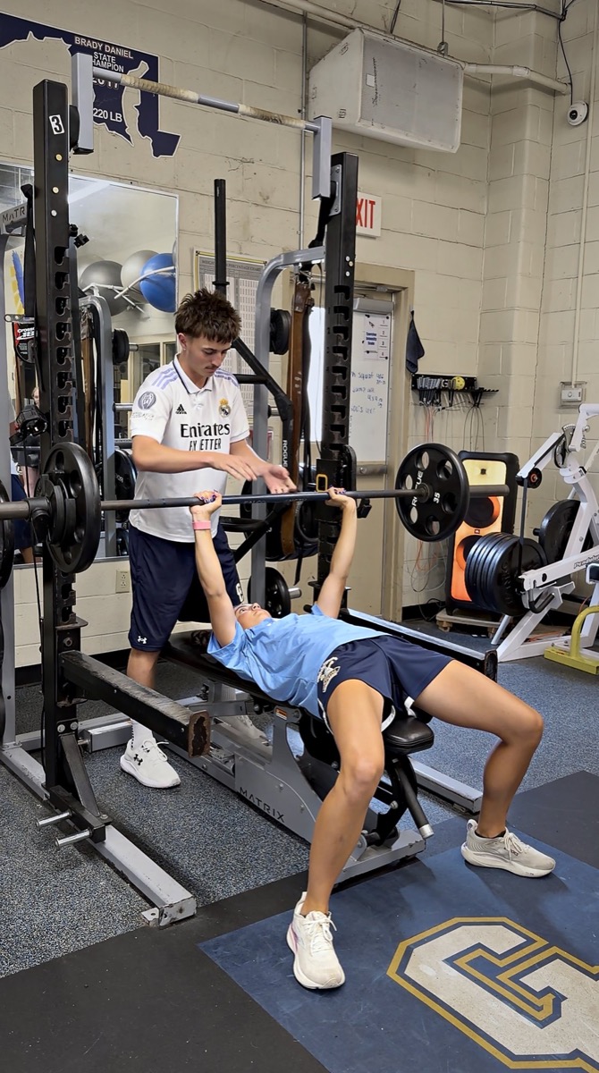 Dani Serrano bench pressing during a training session