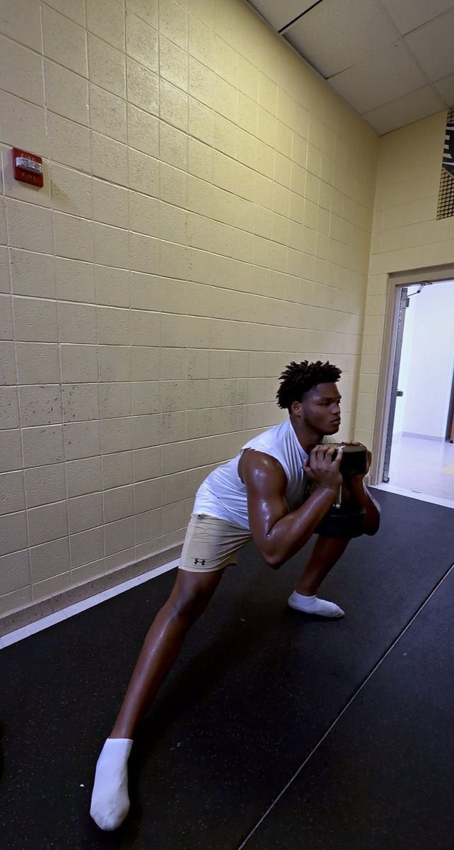 Karon Spencer performing a loaded lunge during training