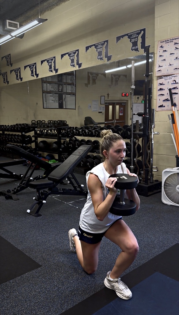 Morgan Shannon performing a weighted lunge during strength training